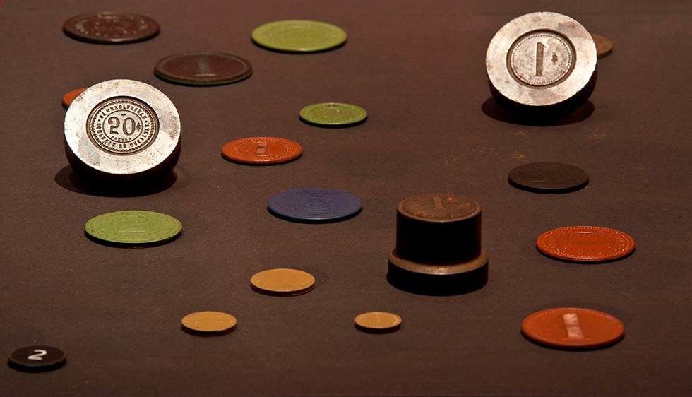 Tokens and a stamp used by northern Chile's saltpeter companies.